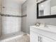 Bathroom featuring tiled walk-in shower, modern vanity with framed mirror and brushed faucet at 107 Carlisle Ct, Kissimmee, FL 34758