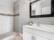 Bathroom featuring tiled walk-in shower, modern vanity with framed mirror and brushed faucet at 107 Carlisle Ct, Kissimmee, FL 34758