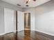 Bedroom with dark wood floors, gray walls, and white doors provide ample storage at 107 Carlisle Ct, Kissimmee, FL 34758