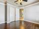 Bedroom with crown molding, ceiling fan, closet, and ensuite bathroom entrance at 107 Carlisle Ct, Kissimmee, FL 34758
