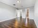 Bedroom featuring wood floors, neutral walls, and multiple entryways at 107 Carlisle Ct, Kissimmee, FL 34758