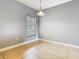 Eat-in kitchen with gray walls, tile floors, and a modern pendant light at 107 Carlisle Ct, Kissimmee, FL 34758