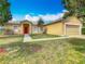Welcoming single-level home with a well-kept lawn, attractive landscaping, and a practical two-car garage at 107 Carlisle Ct, Kissimmee, FL 34758