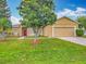Charming single-story home with a well-maintained lawn, lush landscaping, and a vibrant red front door at 107 Carlisle Ct, Kissimmee, FL 34758