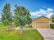 Beautiful one-story home boasting a vibrant green lawn, mature trees, and a convenient two-car garage at 107 Carlisle Ct, Kissimmee, FL 34758