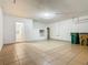 Spacious garage with tiled floor, garage door, overhead lighting, and trash cans at 107 Carlisle Ct, Kissimmee, FL 34758