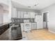 Updated kitchen with granite countertops, white cabinets and stainless steel appliances at 107 Carlisle Ct, Kissimmee, FL 34758