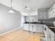 Bright kitchen featuring gray walls, stainless appliances, tile flooring, and granite countertop peninsula at 107 Carlisle Ct, Kissimmee, FL 34758