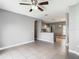 Bright living room with tile floors, view of open kitchen, and neutral gray walls at 107 Carlisle Ct, Kissimmee, FL 34758