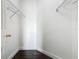 Walk-in closet featuring white walls, dark wood floors, and two wire shelving units at 107 Carlisle Ct, Kissimmee, FL 34758