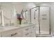 Bathroom featuring a double vanity with sinks, mirrors, and a glass-enclosed shower for a spa-like experience at 112 Southern Pecan Cir # 201, Winter Garden, FL 34787