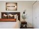 Stylish bedroom showcasing a bed, artwork, side table, and a lamp, creating a comfortable ambiance at 112 Southern Pecan Cir # 201, Winter Garden, FL 34787