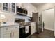 Modern kitchen featuring stainless steel appliances and elegant white cabinets at 112 Southern Pecan Cir # 201, Winter Garden, FL 34787