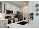 Bright kitchen featuring stainless steel appliances, white countertops, and stylish fixtures at 112 Southern Pecan Cir # 201, Winter Garden, FL 34787