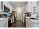 Well-lit kitchen with modern appliances, white cabinets, and dark wood flooring at 112 Southern Pecan Cir # 201, Winter Garden, FL 34787