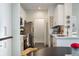 Modern kitchen featuring white cabinets, stainless steel appliances, and elegant hardware at 112 Southern Pecan Cir # 201, Winter Garden, FL 34787