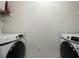 Clean laundry room with white washer and dryer units and overhead shelving at 112 Southern Pecan Cir # 201, Winter Garden, FL 34787