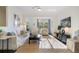 Inviting living room with neutral colors, ceiling fan and an open layout at 112 Southern Pecan Cir # 201, Winter Garden, FL 34787