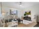 Bright living room with large windows, ceiling fan, and comfortable seating at 112 Southern Pecan Cir # 201, Winter Garden, FL 34787