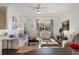 Open-concept living room with abundant natural light, a ceiling fan and view to dining space at 112 Southern Pecan Cir # 201, Winter Garden, FL 34787