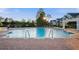Community pool featuring a brick deck, clear blue water, and comfortable lounge chairs for relaxing at 112 Southern Pecan Cir # 201, Winter Garden, FL 34787