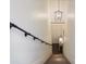 Bright stairway with industrial handrail and modern light fixture at 112 Southern Pecan Cir # 201, Winter Garden, FL 34787