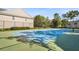 Community tennis court surrounded by lush landscaping, providing a space for recreational activities at 112 Southern Pecan Cir # 201, Winter Garden, FL 34787