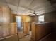 Large basement space with wood paneling and a drop ceiling offers potential for customization at 122 Laurel Dr, Sanford, FL 32773