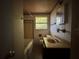 The bathroom includes a bathtub, sink, mirror, toilet, and window at 122 Laurel Dr, Sanford, FL 32773