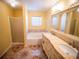 Elegant bathroom boasts a dual sink vanity, soaking tub, and separate shower for a spa-like experience at 1870 Vale Dr, Clermont, FL 34711