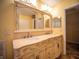 A luxurious bathroom featuring a dual sink vanity with ornate mirror offers plenty of space at 1870 Vale Dr, Clermont, FL 34711