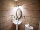 Stylish bathroom with an oval mirror, decorative lighting, and attractive tile work at 1870 Vale Dr, Clermont, FL 34711