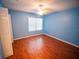 A light-filled bedroom with modern wooden floors makes for a calm and refreshing retreat at 1870 Vale Dr, Clermont, FL 34711