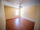 Bright bedroom featuring hardwood floors, a ceiling fan, and a window for natural light at 1870 Vale Dr, Clermont, FL 34711