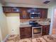 Kitchen with stainless steel appliances, dark cabinets, and a mosaic tile backsplash at 1870 Vale Dr, Clermont, FL 34711