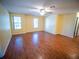 Bright living room with wood floors and ceiling fan provides a comfortable and stylish space at 1870 Vale Dr, Clermont, FL 34711