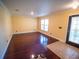 Inviting living room with polished hardwood floors, leading to a front door and ample natural light at 1870 Vale Dr, Clermont, FL 34711