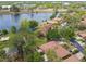 A high angle showcases this home's proximity to a lake and green foliage at 194 Heron Bay Cir, Lake Mary, FL 32746