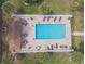 Aerial view of community pool, showcasing layout with tables, chairs, and sun loungers at 194 Heron Bay Cir, Lake Mary, FL 32746