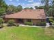 Aerial view of the home showing a well-maintained roof, lush landscaping, and patio area at 194 Heron Bay Cir, Lake Mary, FL 32746