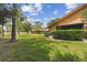 Expansive backyard with a well-manicured lawn, trees, and access to the water at 194 Heron Bay Cir, Lake Mary, FL 32746