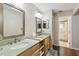 Bathroom featuring double sinks, wooden cabinets, a large mirror, and access to the shower at 194 Heron Bay Cir, Lake Mary, FL 32746