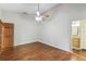 Bedroom featuring hardwood floors, ceiling fan, neutral walls, and a doorway to the bathroom at 194 Heron Bay Cir, Lake Mary, FL 32746