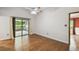 Bedroom featuring hardwood floors, ceiling fan, neutral walls, and sliding glass door to the outside at 194 Heron Bay Cir, Lake Mary, FL 32746