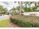 Well-maintained community entrance with a sign surrounded by lush greenery and mature trees at 194 Heron Bay Cir, Lake Mary, FL 32746