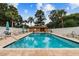 Community pool with patio seating and umbrellas at 194 Heron Bay Cir, Lake Mary, FL 32746