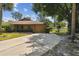Charming single-story home with a well-manicured lawn, a two-car garage, and a circular driveway at 194 Heron Bay Cir, Lake Mary, FL 32746