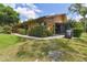Exterior side view showing well-maintained landscaping, patio and grill area, and home design at 194 Heron Bay Cir, Lake Mary, FL 32746
