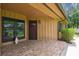 Inviting front porch with brick pavers, stained wood accents, and mature landscaping that provides shade at 194 Heron Bay Cir, Lake Mary, FL 32746