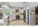 Modern kitchen featuring stainless steel appliances, granite countertops, and white cabinetry at 194 Heron Bay Cir, Lake Mary, FL 32746